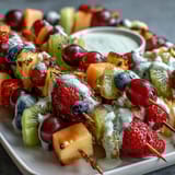 Brightly arranged Rainbow Fruit Skewers with Honey Dip, featuring juicy strawberries, sweet pineapple, and tangy kiwi, served with a creamy honey-yogurt dipping sauce.