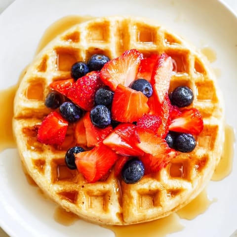 Fluffy waffles, a classic American breakfast, stacked high and ready to be enjoyed.