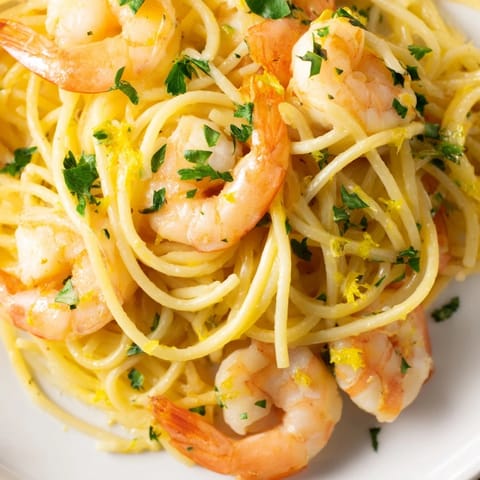 Lemon Butter Shrimp Pasta Lite served over angel hair pasta with a light garlic butter sauce.