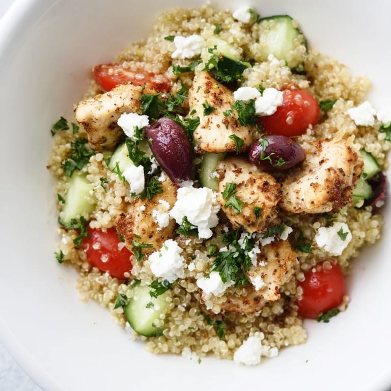 Colorful Mediterranean Chicken Bowl with chickpeas, diced cucumbers, halved cherry tomatoes, and red onion, all tossed in a vibrant lemon-oregano dressing.