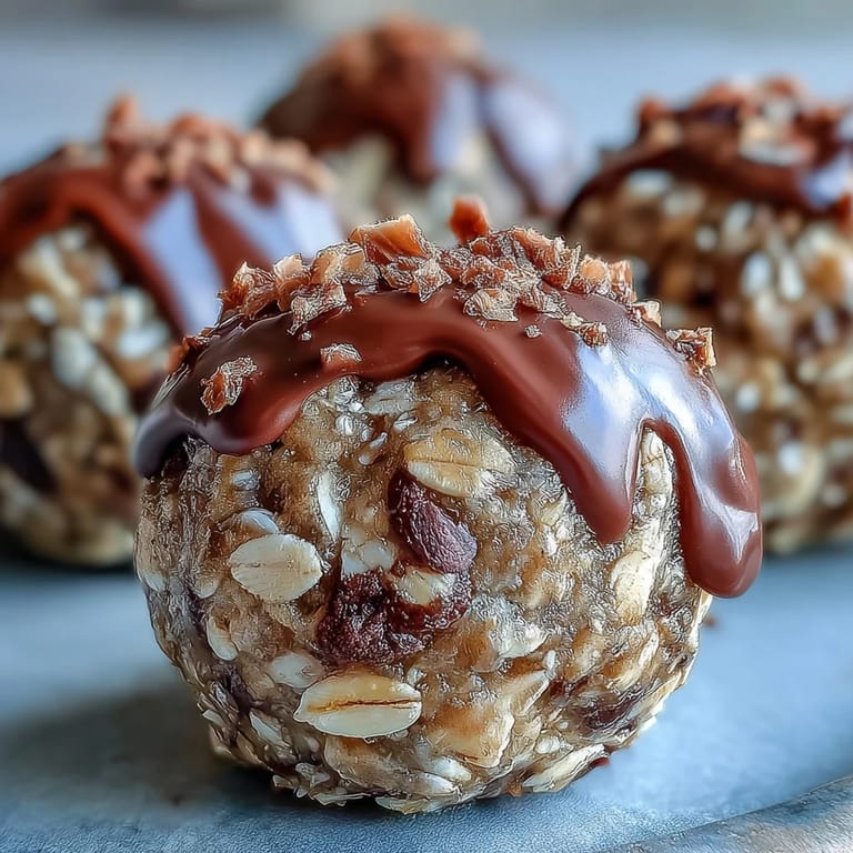 Soft, golden Banana Chocolate Chip Energy Balls speckled with oats and chocolate chips on a rustic countertop.  